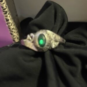 Elegant Silver Ring with Green Gemstone class engraving on it